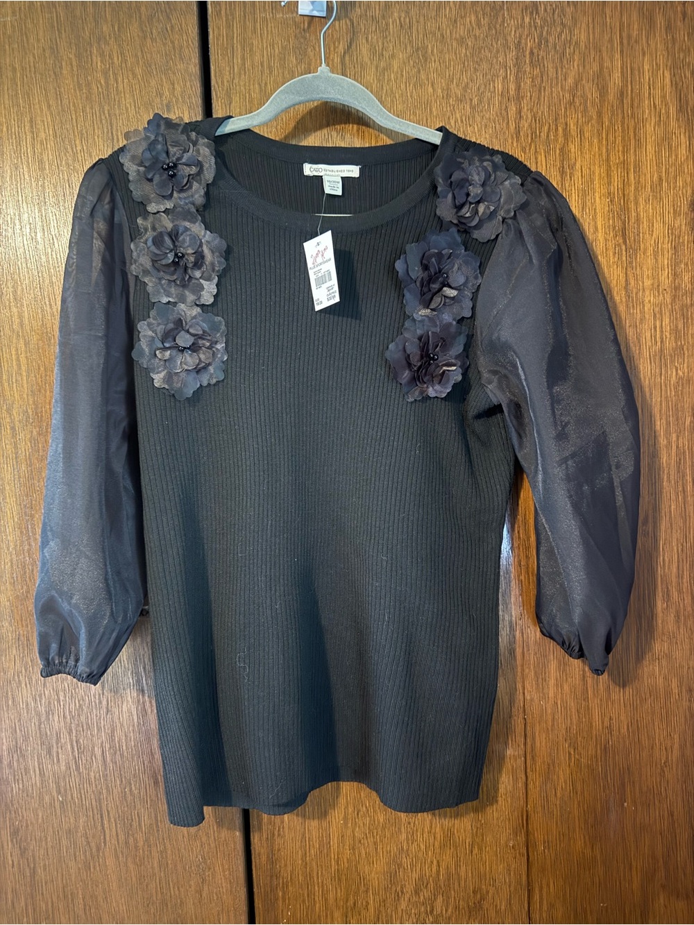 Black sweater with floral appliqués